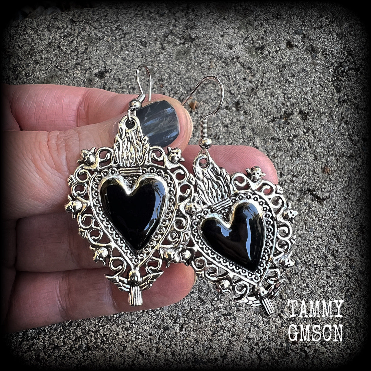 These gorgeous antique silver and enamel 'Black heart' sacred heart earrings are nice and lightweight at just 5 grams a piece and measure just on 6cms from tip to tip.

This pair has been made on stainless steel french hooks to be worn through pierced ears.