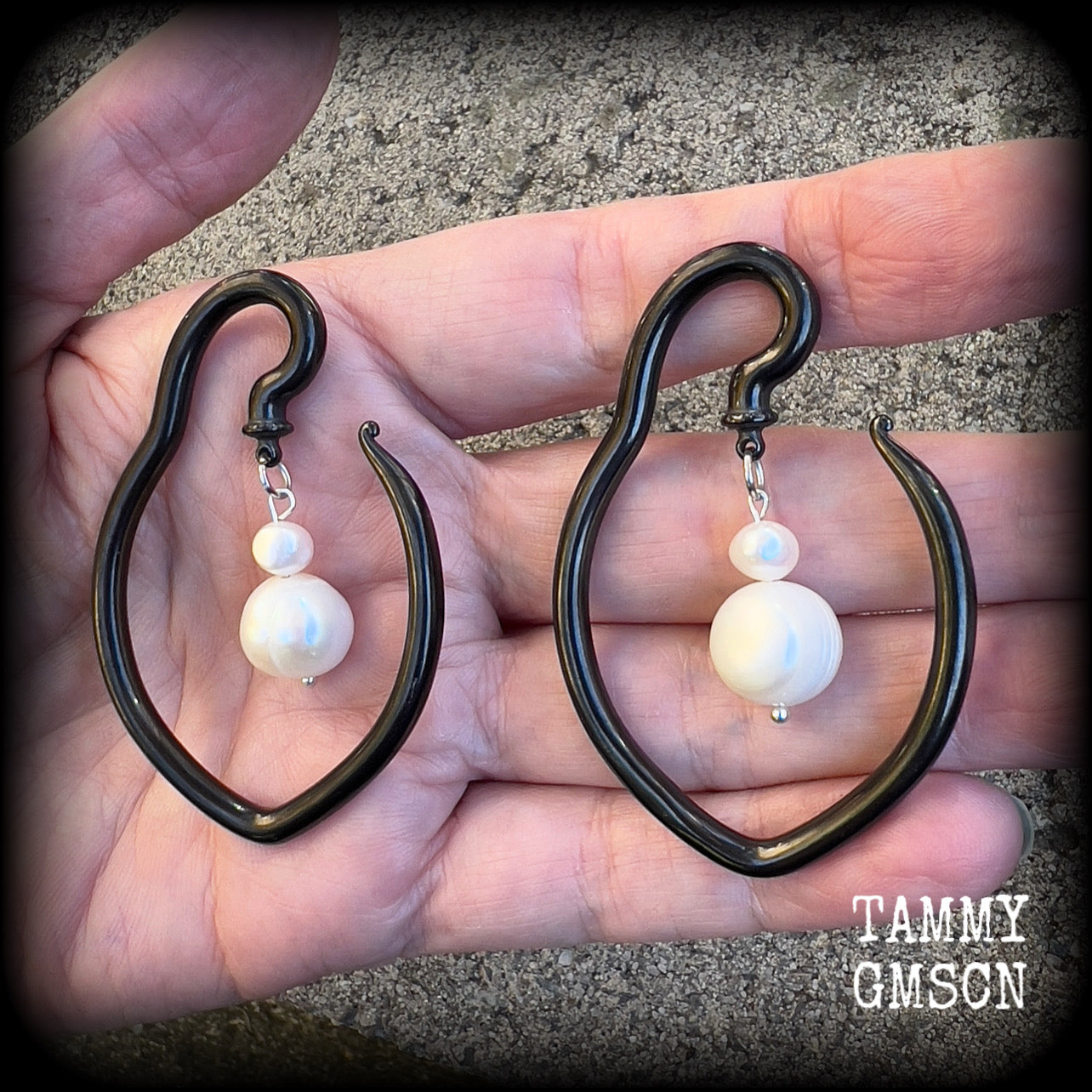 This is a pair of  titanium coated surgical steel hooks and repurposed ocean pearls, suitable to be worn through stretched lobes from 8 gauge (3mm).

Measuring approx 3.5cms across and almost 6cms from top to bottom, these weigh 13 grams a piece.