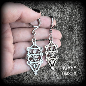 Our 'Tree of Life' gauged earrings feature stunning Kabalistic Tree of Life charms complete with sephiroth symbols. These earrings and are nice and dangly at just on 7cms, and weigh 8 grams a piece.
This pair has been made on 6 gauge (4mm) surgical steel full curl hooks, to be worn in stretched lobes.