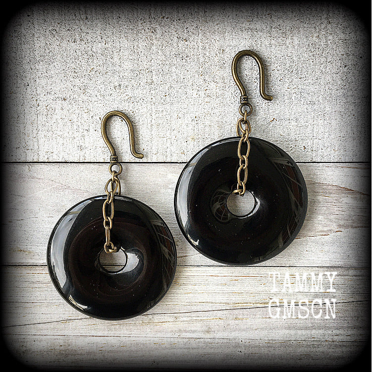 Black obsidian and antique bronze earrings measuring 9cms from tip to tip, weighing approx. 27 grams a piece.
This pair have been made with small antique bronze shephards hooks, to be worn through earlets in stretched lobes from 8 gauge (3mm).