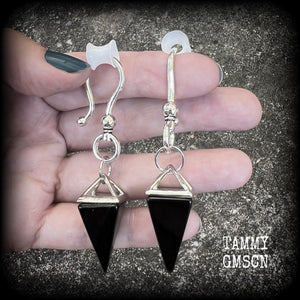 This is a pair of gorgeous pitch black onyx gemstone earrings, not too heavy at approx 10 grams a piece, and measuring just on 7cms from tip to tip.

This pair has been made with large antique silver shephards hooks, to be worn through silicone earlets in stretched lobes from 2 gauge (6mm).