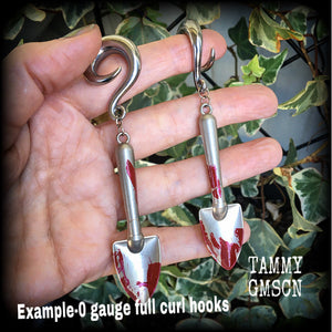 Our awesome ‘Grave digger’ gauged earrings feature a pair of b l o o d spattered stainless steel shovels weighing in at 24 grams a piece, and are nice and dangly at just over 10cms.

This pair has been made on 0 gauge (8mm) surgical steel full curl hooks, to be worn in stretched lobes.