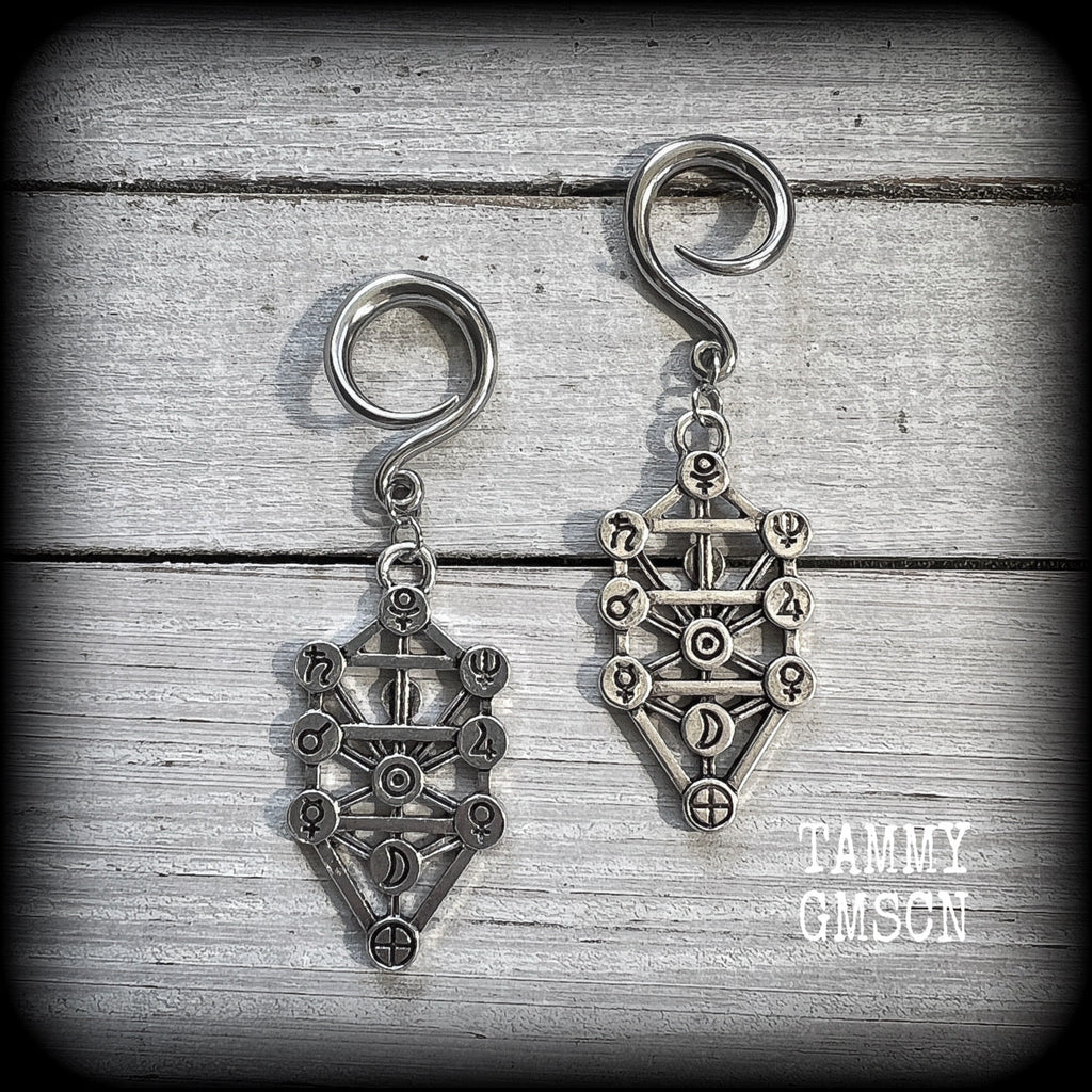 Our 'Tree of Life' gauged earrings feature stunning Kabalistic Tree of Life charms complete with sephiroth symbols. These earrings and are nice and dangly at just on 7cms, and weigh 8 grams a piece.
This pair has been made on 6 gauge (4mm) surgical steel full curl hooks, to be worn in stretched lobes.