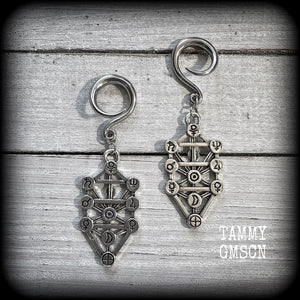 Our 'Tree of Life' gauged earrings feature stunning Kabalistic Tree of Life charms complete with sephiroth symbols. These earrings and are nice and dangly at just on 7cms, and weigh 8 grams a piece.
This pair has been made on 6 gauge (4mm) surgical steel full curl hooks, to be worn in stretched lobes.