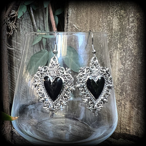 These gorgeous antique silver and enamel 'Black heart' sacred heart earrings are nice and lightweight at just 5 grams a piece and measure just on 6cms from tip to tip.

This pair has been made on stainless steel french hooks to be worn through pierced ears.