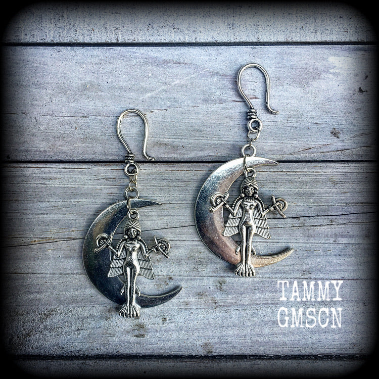 These beautiful earrings feature the image of Lilith sitting atop an antique silver crescent moon, are lovely and light weight at 10 grams a piece, and nice and dangly, measuring 7.5 cms from tip to tip..

This pair have been made on small antique silver shephard hooks, to be worn through silicone earlets in stretched lobes from 8 gauge (3mm).
