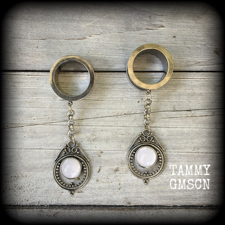 These beautiful boho tunnel dangles feature gorgeous translucent opalite and antique silver drop pendants, are light weight, weighing approx 10 grams each and measure just on 7cms from tip to tip.

This pair has been made with 5/8" gauge (16mm) surgical steel screw fit tunnels-for stretched lobes.