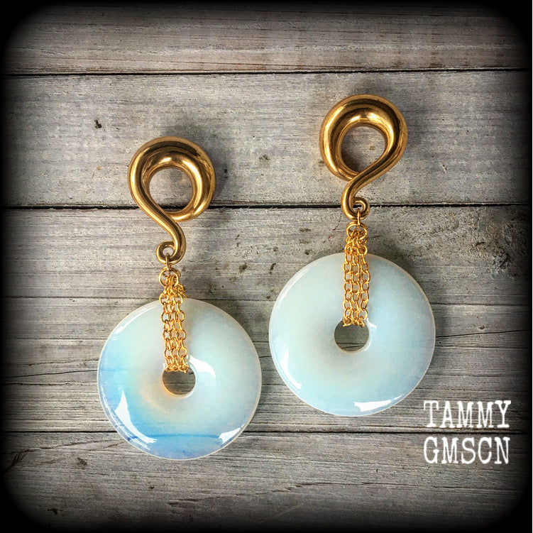 Featuring a pair of beautiful milky white opalite donut stones with antique gold chain, this pair weighs approx 49 grams a piece, and measure 10cms from tip to tip.

This pair have been made with 00 gauge (10mm) surgical steel full curl hooks, to be worn in stretched lobes.

