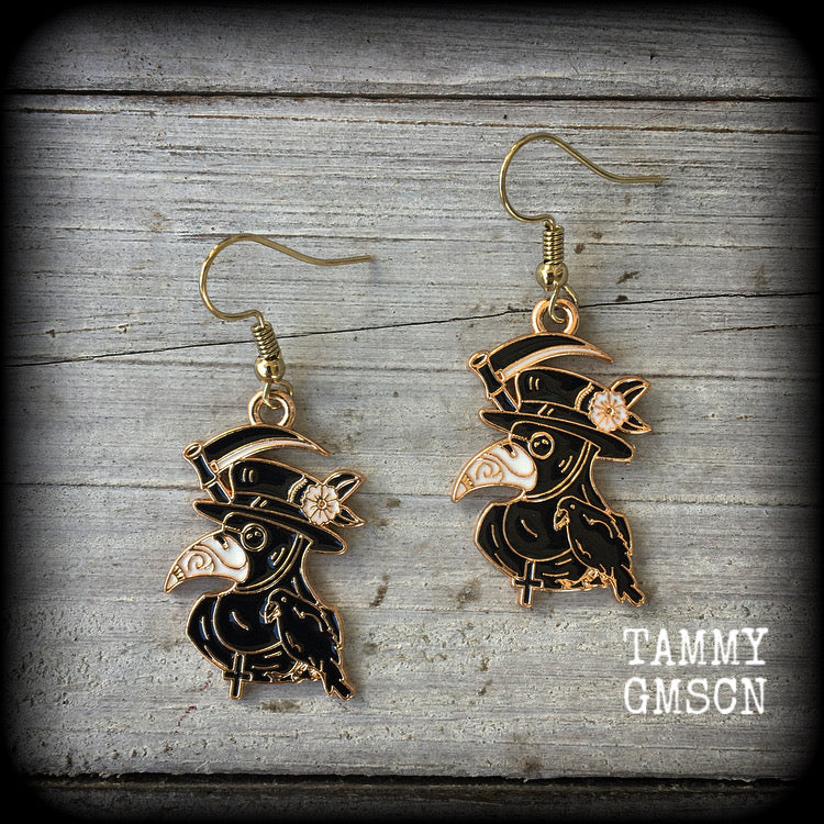 Featuring classic black and white enamel plague doctors with scythe, these awesome earrings measure approx 5cms from tip to tip, and weigh only a few grams each.

This pair has been made with antique gold french hooks, suitable for pierced ears.