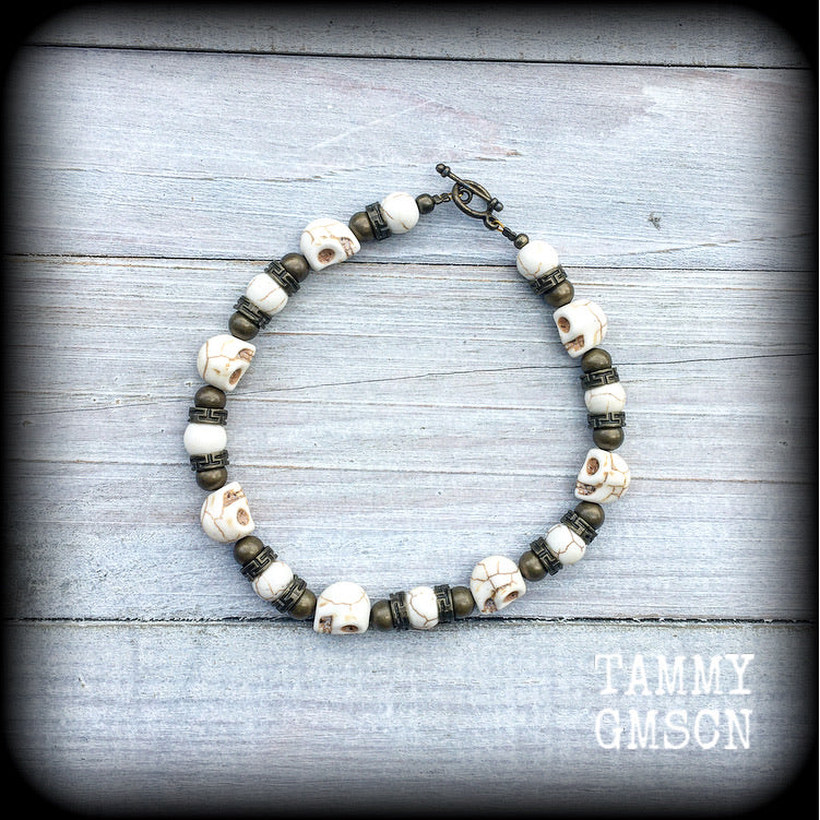 This gorgeous bracelet features bone white stone skulls, with antique bronze beads, measureing approx 23cms while laying flat and fastening with an antique bronze toggle clasp.

If you would prefer this bracelet made with a lobster clasp (rather than the toggle clasp shown), please be sure to choose that option when you go though checkout.