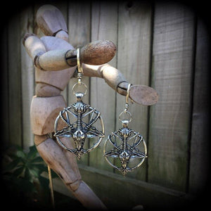 These gorgeous gothic earrings feature an antique silver Baphomet, are light weight (8 grams a piece) and nice and dangly, measuring 8cms from tip to tip.

This pair has been made on small antique silver shephards hooks to be worn through silicone earlets in stretched lobes from 8 gauge (3mm).

