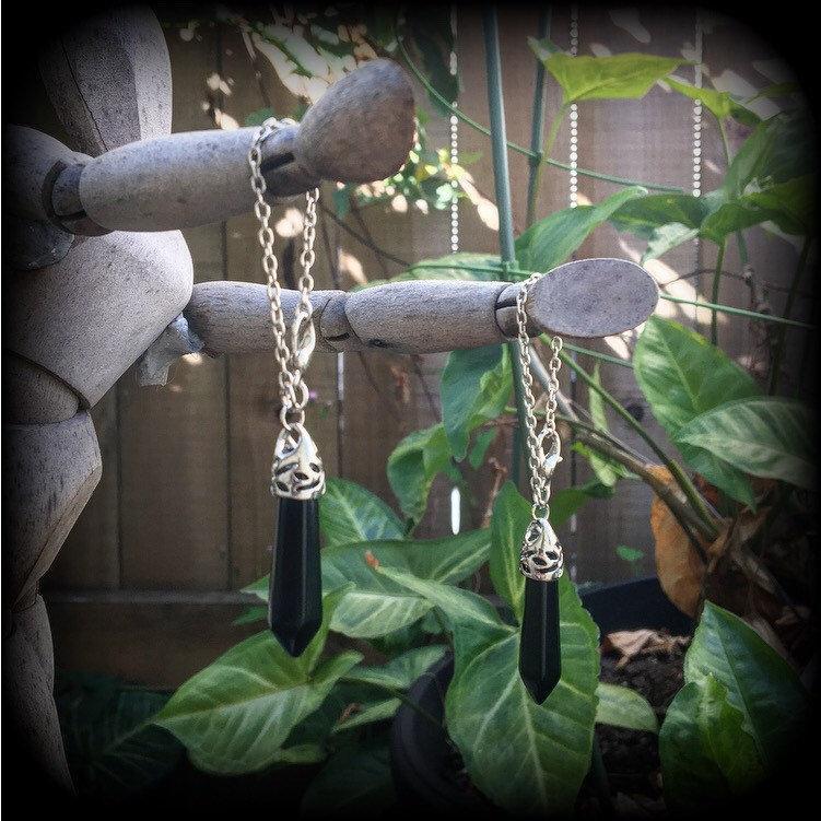 This gorgeous pair of pitch black obsidian earrings are nice and lightweight and nice and dangly, measuring just on 6cms from tip to tip and weighing in at 5 grams each piece.
This pair have been made on our super versatile antique silver chain and lobster clasp 4mm option, to be worn through silicone earlets in stretched lobes from 6 gauge (4mm).