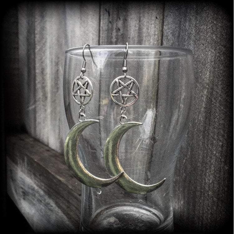 Featuring large antique silver crescent moons hanging from antique silver inverted pentagram charms, these gorgeous gothic earrings measure just on 10cms from tip to tip and weigh approx 6cm each.

This pair has been made with stainless steel french hooks, for pierced ears.