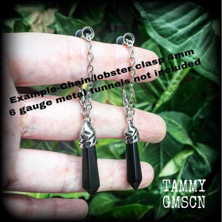 This gorgeous pair of pitch black obsidian earrings are nice and lightweight and nice and dangly, measuring just on 6cms from tip to tip and weighing in at 5 grams each piece.
This pair have been made on our super versatile antique silver chain and lobster clasp 4mm option, to be worn through silicone earlets in stretched lobes from 6 gauge (4mm).