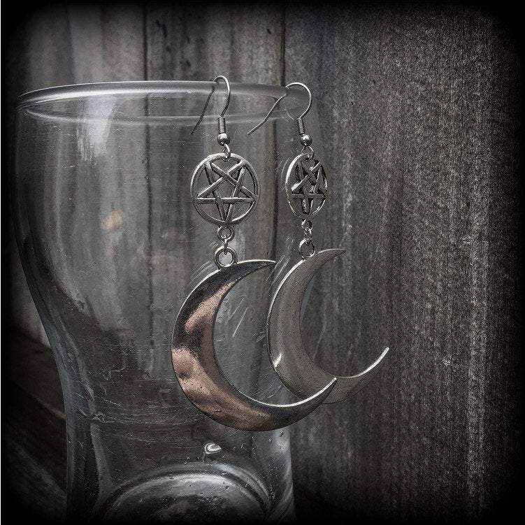 Featuring large antique silver crescent moons hanging from antique silver inverted pentagram charms, these gorgeous gothic earrings measure just on 10cms from tip to tip and weigh approx 6cm each.

This pair has been made with stainless steel french hooks, for pierced ears.