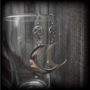 Featuring large antique silver crescent moons hanging from antique silver inverted pentagram charms, these gorgeous gothic earrings measure just on 10cms from tip to tip and weigh approx 6cm each.

This pair has been made with stainless steel french hooks, for pierced ears.