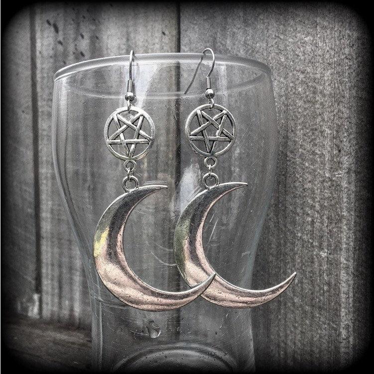 Featuring large antique silver crescent moons hanging from antique silver inverted pentagram charms, these gorgeous gothic earrings measure just on 10cms from tip to tip and weigh approx 6cm each.

This pair has been made with stainless steel french hooks, for pierced ears.