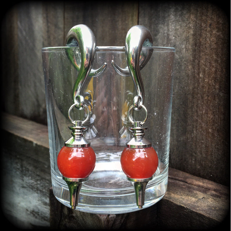 These gorgeous gauged earrings have been made with beautiful red jasper pendulums, measuring just under 9cms from tip to tip, and weighing approx 34 grams each.

This pair has been made on 00 gauge (10mm) surgical steel full curl hooks, to be worn in stretched lobes.