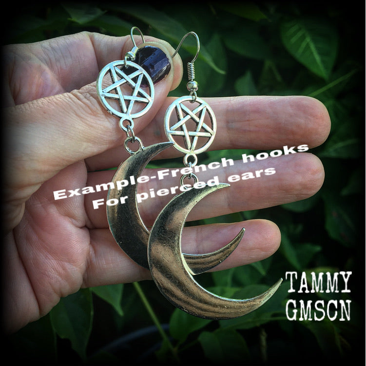 Featuring large antique silver crescent moons hanging from antique silver inverted pentagram charms, these gorgeous gothic earrings measure just on 10cms from tip to tip and weigh approx 6cm each.

This pair has been made with stainless steel french hooks, for pierced ears.