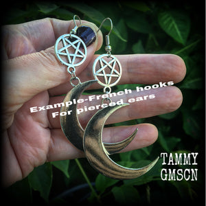 Featuring large antique silver crescent moons hanging from antique silver inverted pentagram charms, these gorgeous gothic earrings measure just on 10cms from tip to tip and weigh approx 6cm each.

This pair has been made with stainless steel french hooks, for pierced ears.