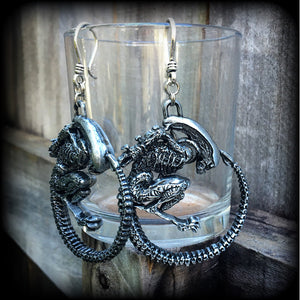 These awesome earrings feature a pair of large pewter Alien Queen Xenomorphs, measuring 9cms from tip to tip (nice and big), and weigh 38 grams each (these are HEAVY).

This pair have been made on small antique silver shephard hooks to be worn in stretched lobes with silicone earlets from 8 gauge (3mm).