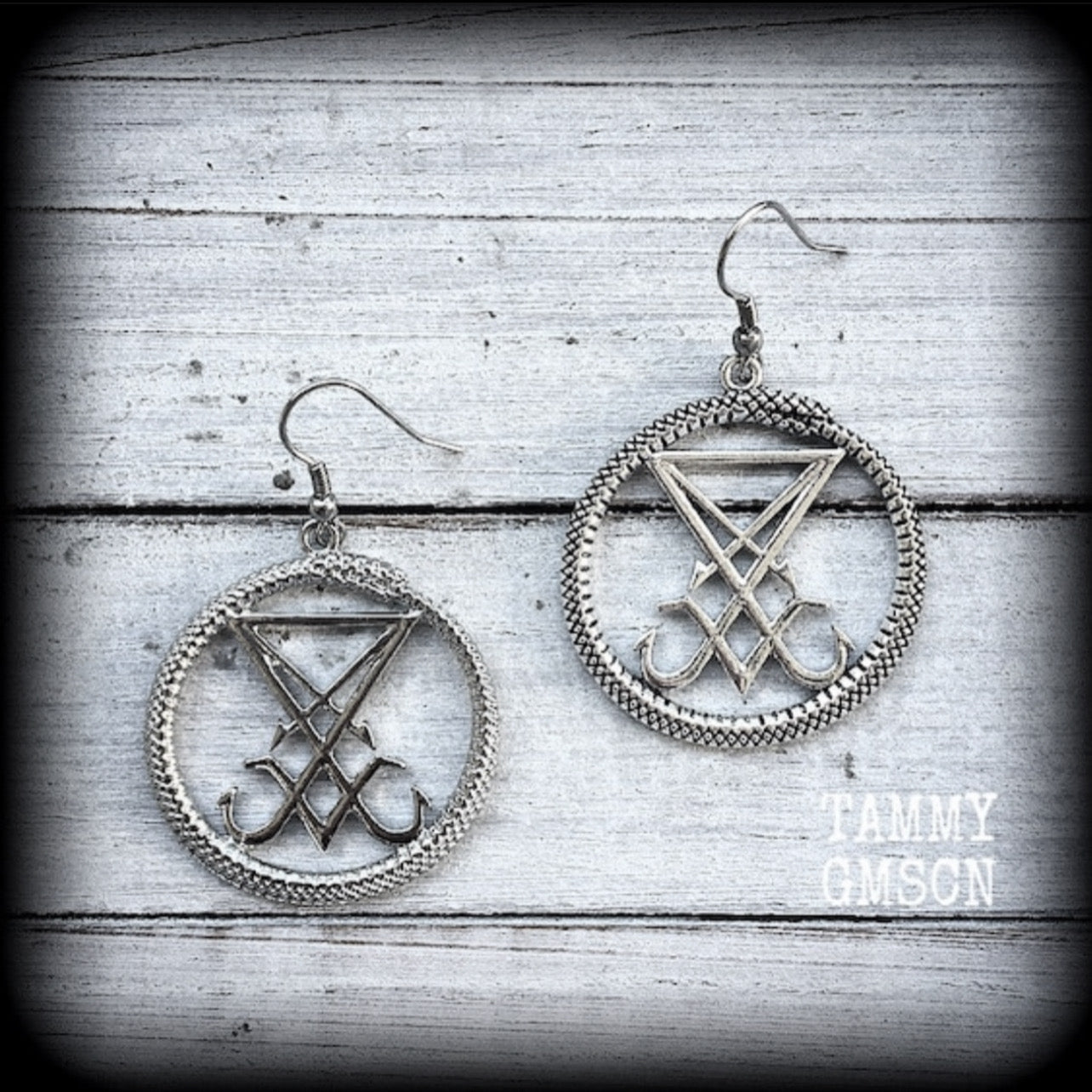 These gorgeous antique silver 'Ouroboros and Sigil of Lucifer' earrings are light weight at approx 5 grams a piece, and nice and dangly, measuring just over 5cms from tip to tip.
This pair has been made with stainless steel french hooks, suitable for pierced ears.