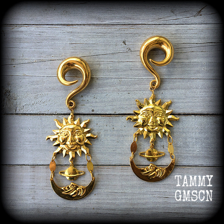 These earrings feature an antique crescent moon hanging below a ringed planet and gold sun.
Measuring 11 cms from tip to tip, these are nice and dangly, and weigh approx 32 grams each, made on 0 gauge (8mm) titanium coated surgical steel full curls.
