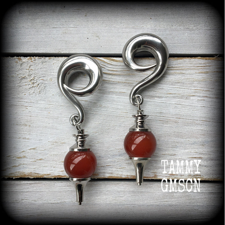 These gorgeous gauged earrings have been made with beautiful red jasper pendulums, measuring just under 9cms from tip to tip, and weighing approx 34 grams each.

This pair has been made on 00 gauge (10mm) surgical steel full curl hooks, to be worn in stretched lobes.