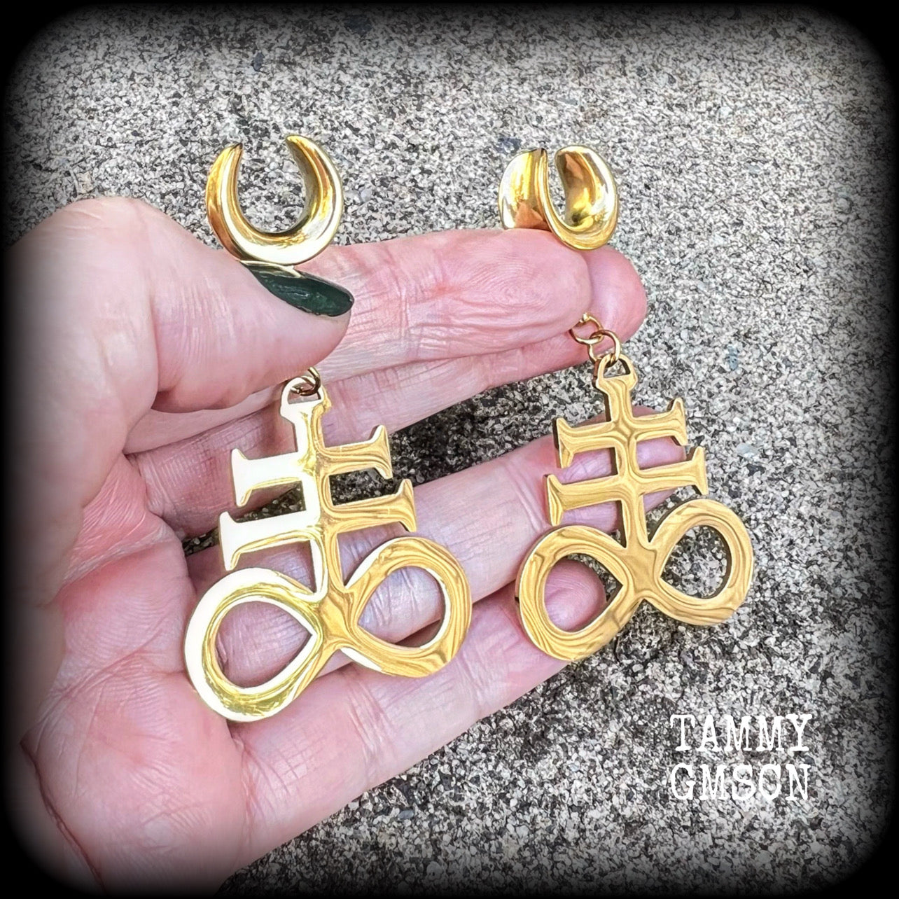 These gorgeous gold titanium earrings feature large Sigil of sulphur brimstone charms, weighing approx 8 grams each, and measuring around 7 cms from tip to tip.
This pair has been made on 1/2" gauge (12mm) surgical steel cradles, to be worn in stretched lobes.