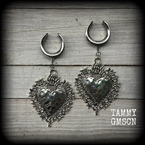These gorgeous antique silver gauged earrings feature big beautiful sacred hearts, measuring 11cms from tip to tip, and weighing approx 21 grams each.

This pair has been made on 1" gauge (25mm) surgical steel cradles, to be worn in stretched lobes.