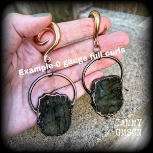This is a pair of goregous shimmering labradorite and copper plate gauged earrings, featuring a pair of beautiful big labradorite gemstones enclosed in rustic ornate copper plate detail, this pair of gauged earrings weighs approx 22 grams a piece, not too heavy, and measure just under 9cms from tip to tip.

These earrings have been made on 0 gauge (8mm) surgical steel full curl hooks, to be worn in stretched lobes.