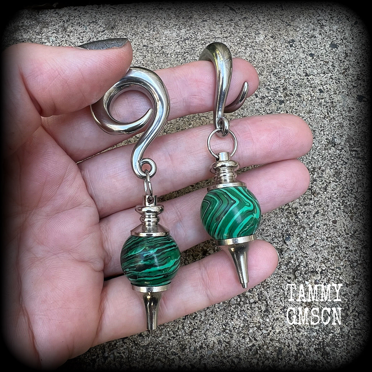 These gorgeous earrings feature deep green Malachite pendulums, weighing in at approx 26 grams each, and measure just on 8 cms from tip to tip, nice and dangly.

This pair has been made with 0 gauge (8mm) surgical steel full curl hooks, suitable for stretched lobes. 