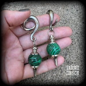 These gorgeous earrings feature deep green Malachite pendulums, weighing in at approx 26 grams each, and measure just on 8 cms from tip to tip, nice and dangly.

This pair has been made with 0 gauge (8mm) surgical steel full curl hooks, suitable for stretched lobes. 