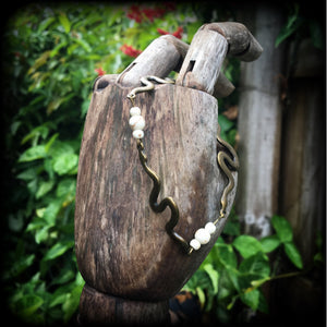 Featuring three antique bronze snake charms moulded to fit your wrist with small bone white howlite stone beads, this bracelet measures just on 20cms from tip to tip when laid flat and fastens with a bronze tone toggle clasp.