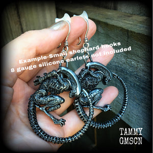 These awesome earrings feature a pair of large pewter Alien Queen Xenomorphs, measuring 9cms from tip to tip (nice and big), and weigh 38 grams each (these are HEAVY).

This pair have been made on small antique silver shephard hooks to be worn in stretched lobes with silicone earlets from 8 gauge (3mm).