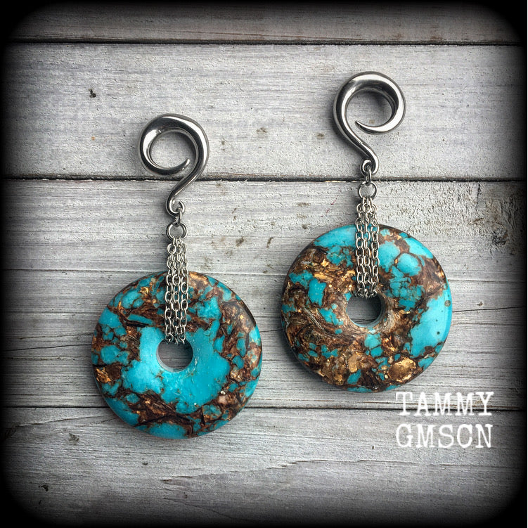 These earrings feature sky blue turquoise and bronzite gemstones cradled in antique silver chain. This pair weighs approx 32 grams a piece, and measure 10cms from tip to tip.
These have been made on 6 gauge (4mm) surgical steel full curl hooks.