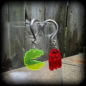 These super rad earrings feature classic acrylic pixelated Pac man and Blinky charms, measuring 5 cms from tip to tip, weighing in at only 4 grams each.
This pair has been made on 6 gauge (4mm) surgical steel full curl hooks, suitable for stretched lobes.