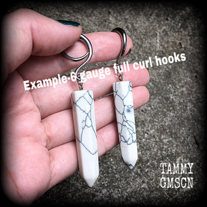 These earrings are made with beautiful white howlite stone points, measuring just on 8cms from tip to tip, and weighing approx 13grams each.
This pair has been made on 6 gauge (4mm) surgical steel full curl hooks, to be worn in stretched lobes.