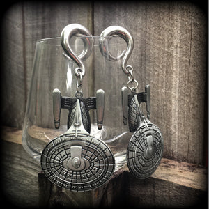 These gorgeous gauged earrings feature the Star Trek USS Enterprise, measuring just on 10cms from tip to tip and weighing approx 45 grams a piece, these earrings are BIG, DANGLY and HEAVY.

This pair has been made on 0 gauge (8mm) surgical steel full curl hooks, to be worn in stretched lobes.
