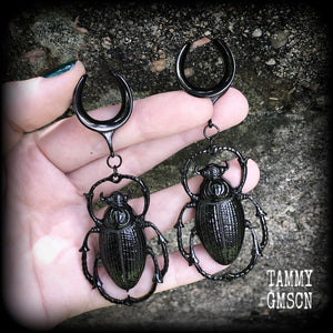 These gorgeous black enamel 'Scarab beetle' gauged earrings measure approx 9cms from tip to tip, and weigh approx. 16 grams a piece, not too heavy.
This pair has been made on 3/4" gauge (19mm) gauge surgical steel cradles, to be worn in stretched lobes.