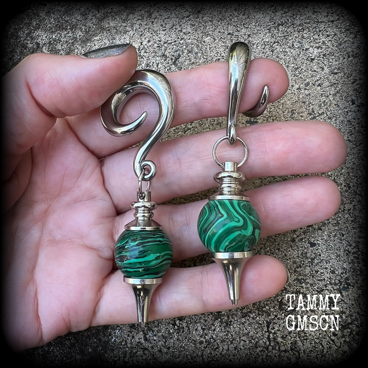 These gorgeous earrings feature deep green Malachite pendulums, weighing in at approx 26 grams each, and measure just on 8 cms from tip to tip, nice and dangly.

This pair has been made with 0 gauge (8mm) surgical steel full curl hooks, suitable for stretched lobes. 