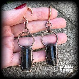 Featuring a pair of beautiful raw black tourmaline gemstones enclosed in rustic ornate copper plate detail, this pair of gorgeous gauged earrings weighs approx 16 grams a piece, and measure approx 8cms from tip to tip.

This pair have been made on 6 gauge (4mm) rose gold titanium coated surgical steel half curl hooks, suitable for stretched lobes.

