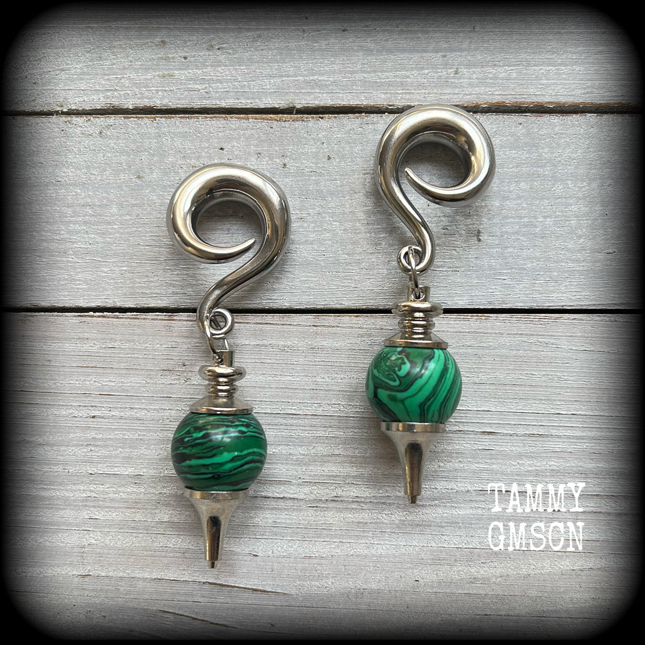 These gorgeous earrings feature deep green Malachite pendulums, weighing in at approx 26 grams each, and measure just on 8 cms from tip to tip, nice and dangly.

This pair has been made with 0 gauge (8mm) surgical steel full curl hooks, suitable for stretched lobes. 