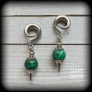 These gorgeous earrings feature deep green Malachite pendulums, weighing in at approx 26 grams each, and measure just on 8 cms from tip to tip, nice and dangly.

This pair has been made with 0 gauge (8mm) surgical steel full curl hooks, suitable for stretched lobes. 