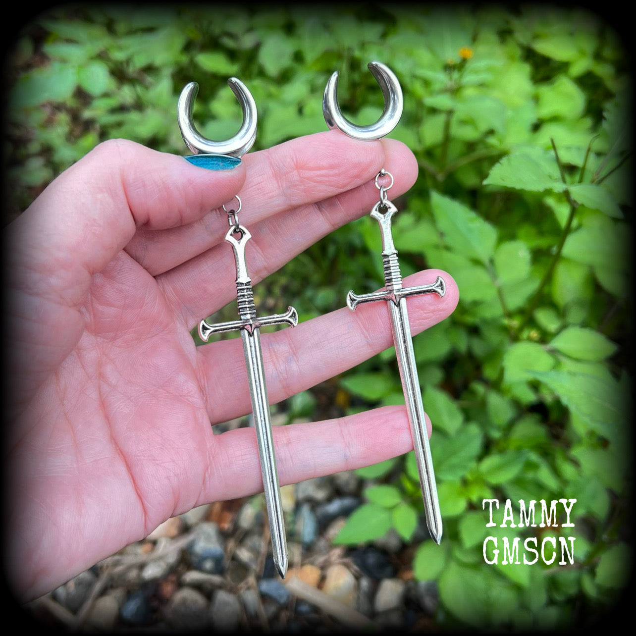 Our 'Ace of Swords' ear hangers feature a gorgeous long antique silver sword pendant, measuring just over 12cms from tip to tip, and weighing approx 9 grams each.

This pair has been made on 9/16" (14mm) surgical steel cradles, to be worn in stretched lobes.
