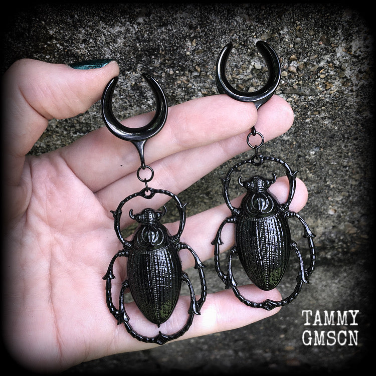 These gorgeous black enamel 'Scarab beetle' gauged earrings measure approx 9cms from tip to tip, and weigh approx. 16 grams a piece, not too heavy.
This pair has been made on 3/4" gauge (19mm) gauge surgical steel cradles, to be worn in stretched lobes.