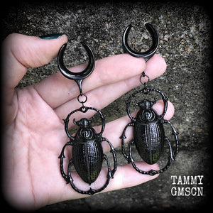 These gorgeous black enamel 'Scarab beetle' gauged earrings measure approx 9cms from tip to tip, and weigh approx. 16 grams a piece, not too heavy.
This pair has been made on 3/4" gauge (19mm) gauge surgical steel cradles, to be worn in stretched lobes.