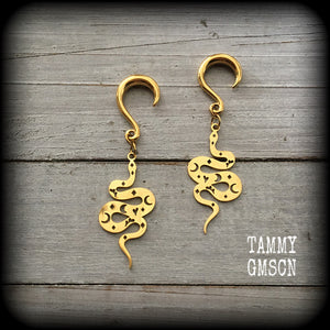 Inspired by the Voodoo Sky-father Damballah, these gorgeous earrings feature gold stainless steel celestial serpents, super lightweight at only a few grams a piece, and mesure just on 6.5cms from tip to tip.
These earrings have been made on 6 gauge (4mm) surgical steel half curl hooks, suitable for stretched lobes.

