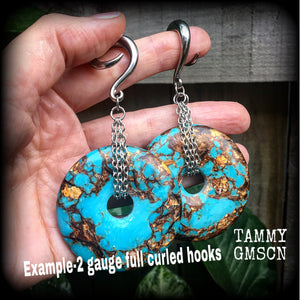 These earrings feature sky blue turquoise and bronzite gemstones cradled in antique silver chain. This pair weighs approx 32 grams a piece, and measure 10cms from tip to tip.
These have been made on 6 gauge (4mm) surgical steel full curl hooks.