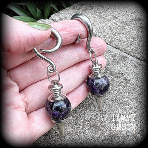 Featuring a pair of beautiful plump purple amethyst pendulums, this pair of earrings weighs approx 21 grams a piece and measure just over 7cms from tip to tip.
This pair have been made on 2 gauge (6mm) surgical steel full curl hooks, to be worn in stretched lobes.